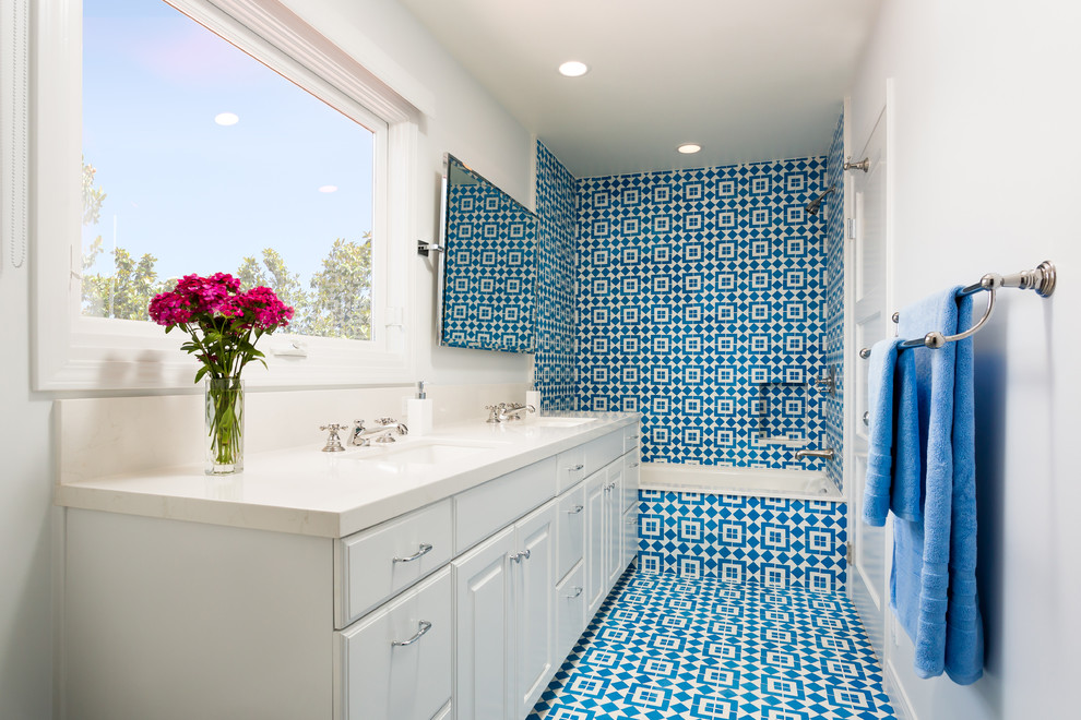 Design ideas for a medium sized classic ensuite bathroom in Los Angeles with a submerged sink, raised-panel cabinets, white cabinets, a built-in bath, a shower/bath combination, blue tiles, blue walls, ceramic flooring, cement tiles, engineered stone worktops, a two-piece toilet, blue floors and an open shower.