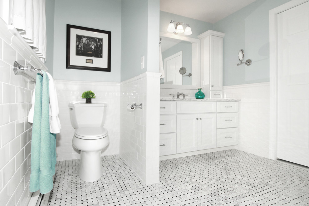 Example of a large transitional master white tile and porcelain tile marble floor and gray floor bathroom design in Boston with shaker cabinets, white cabinets, a two-piece toilet, blue walls, an undermount sink and quartz countertops