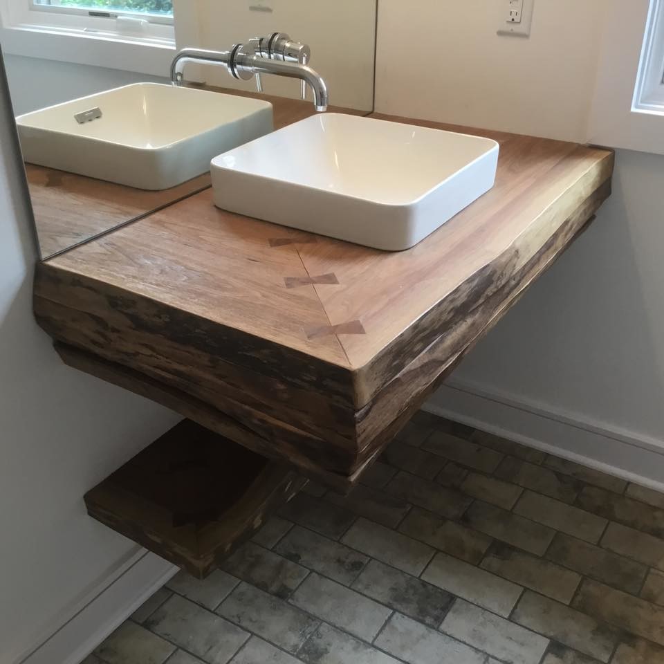 Example of a small mountain style 3/4 black floor bathroom design in Indianapolis with white walls, a vessel sink and wood countertops