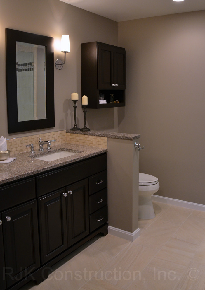 Cette image montre une salle de bain design avec un lavabo encastré, un plan de toilette en granite et un mur beige.