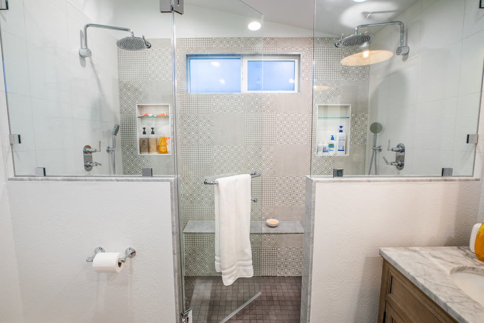 Inspiration för ett mellanstort funkis grå grått en-suite badrum, med luckor med lamellpanel, skåp i slitet trä, en dubbeldusch, en vägghängd toalettstol, grå kakel, vita väggar, cementgolv, ett undermonterad handfat, granitbänkskiva och dusch med gångjärnsdörr