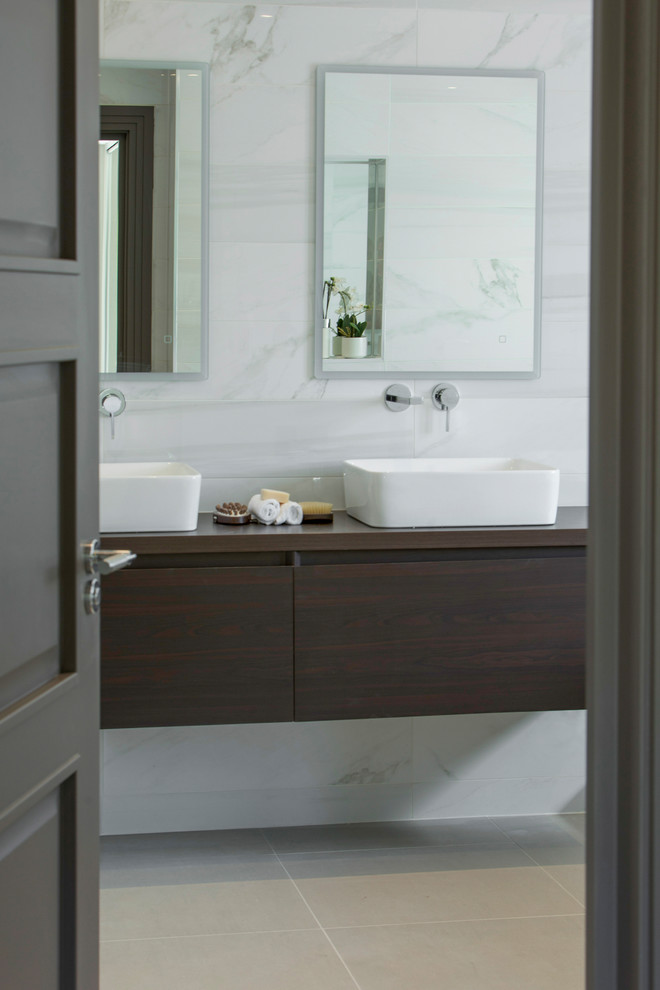 Inspiration for a contemporary ensuite bathroom in London with white tiles and marble tiles.