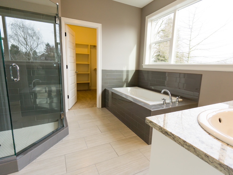 Large traditional ensuite bathroom in Portland with white cabinets, a built-in bath, a corner shower, beige walls, medium hardwood flooring, a submerged sink, grey tiles and granite worktops.