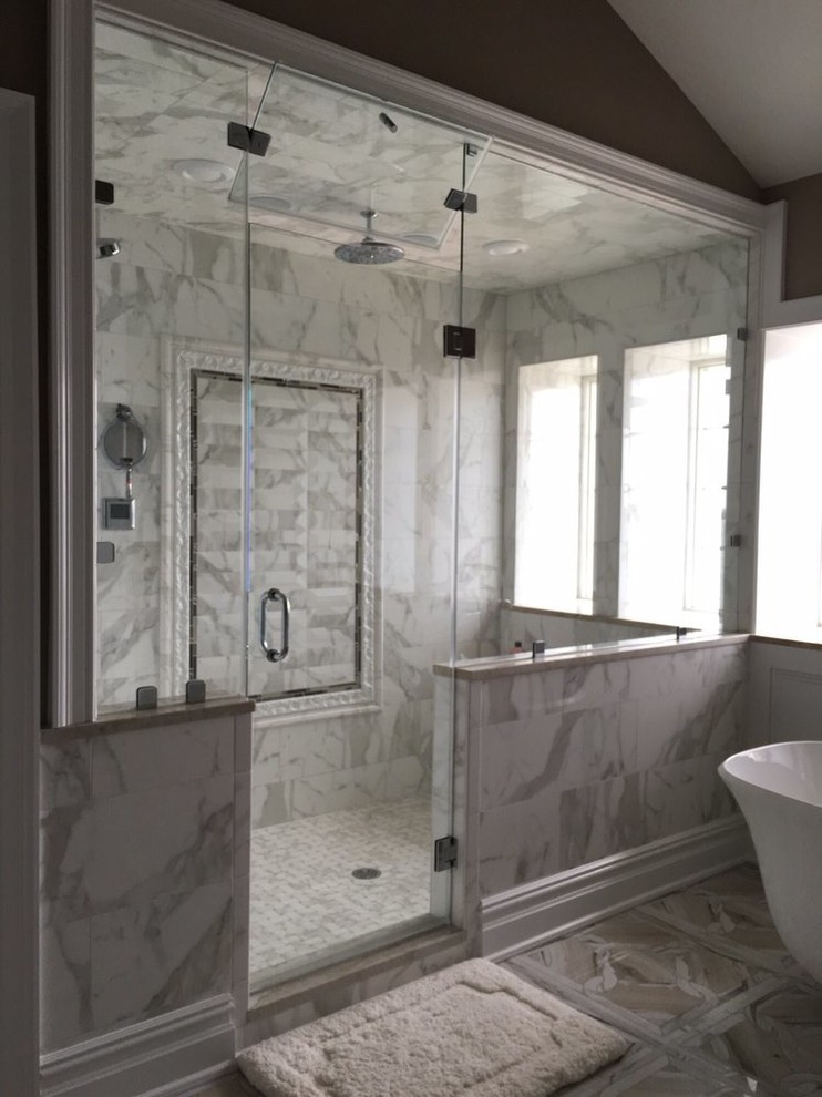 This is an example of a medium sized classic bathroom in New York with a freestanding bath, a double shower, black tiles, stone tiles and marble flooring.