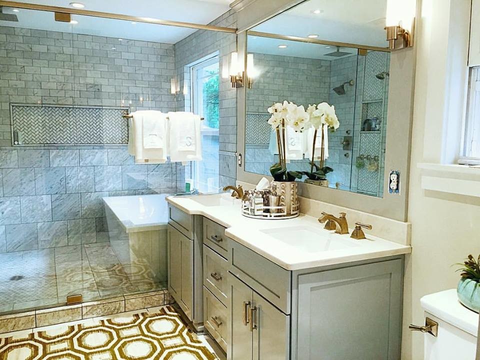 This is an example of a medium sized classic ensuite bathroom in Nashville with freestanding cabinets, grey cabinets, a freestanding bath, a walk-in shower, a one-piece toilet, white tiles, stone tiles, grey walls, a submerged sink and marble worktops.