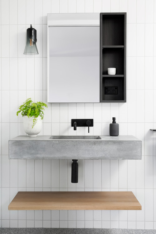 Concrete Elegance: A Gray White Bathroom with a Concrete Vanity and Vertical Backsplash