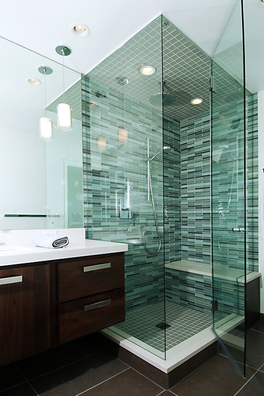 Photo of a small modern shower room bathroom in Denver with flat-panel cabinets, dark wood cabinets, a corner shower, a one-piece toilet, green tiles, matchstick tiles, white walls, porcelain flooring, a submerged sink and quartz worktops.