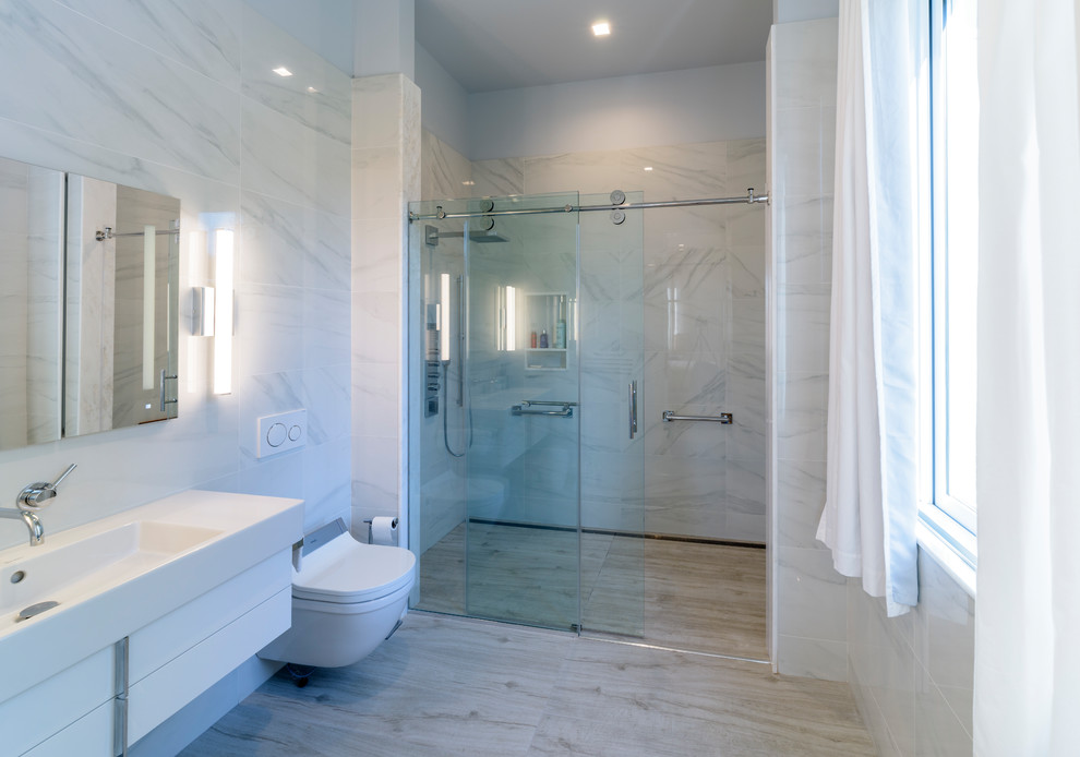 Inspiration for a small modern 3/4 black and white tile, multicolored tile and matchstick tile porcelain tile and gray floor bathroom remodel in New York with flat-panel cabinets, white cabinets, a bidet, multicolored walls, an integrated sink, solid surface countertops and white countertops