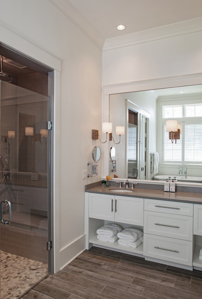 Inspiration for a coastal master gray tile and ceramic tile ceramic tile and gray floor bathroom remodel in Other with shaker cabinets, white cabinets, white walls, an undermount sink, quartz countertops, a hinged shower door and gray countertops