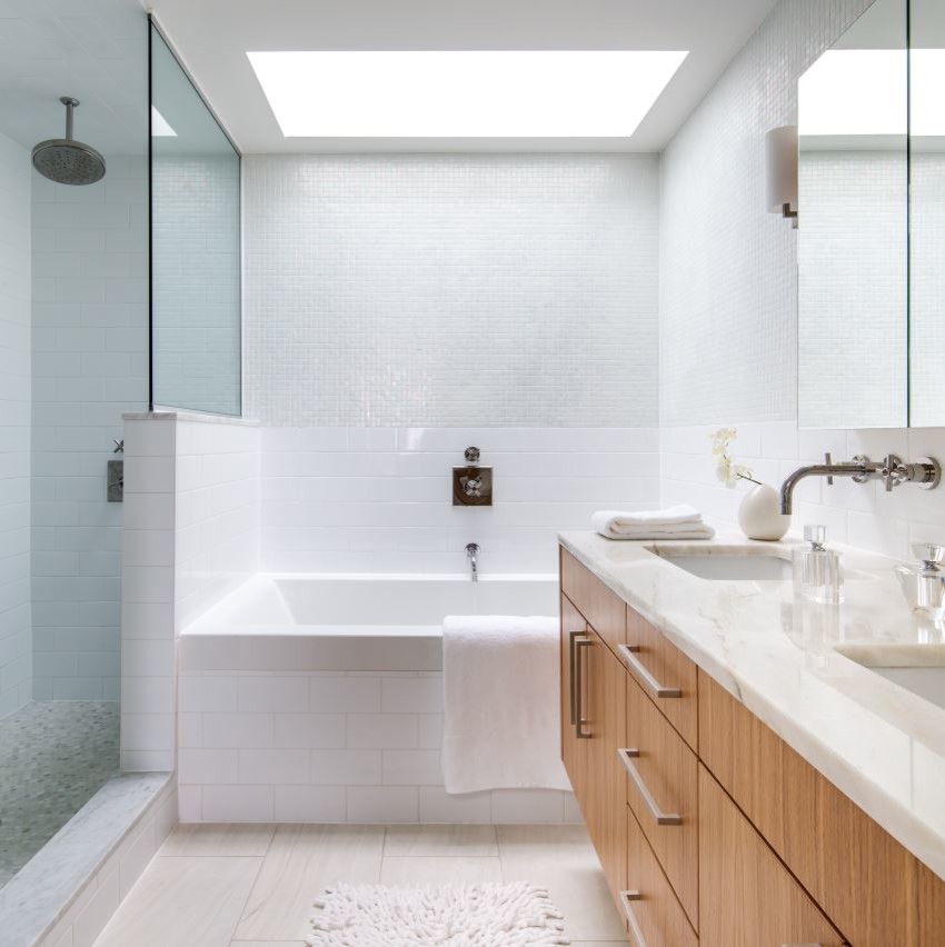 Example of a mid-sized trendy master white tile and subway tile ceramic tile and beige floor bathroom design in New York with flat-panel cabinets, light wood cabinets, white walls, an undermount sink and marble countertops