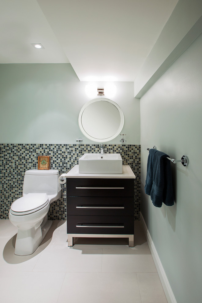 Inspiration for a small transitional blue tile and mosaic tile porcelain tile alcove shower remodel in Toronto with a vessel sink, flat-panel cabinets, dark wood cabinets, quartz countertops, a one-piece toilet and blue walls