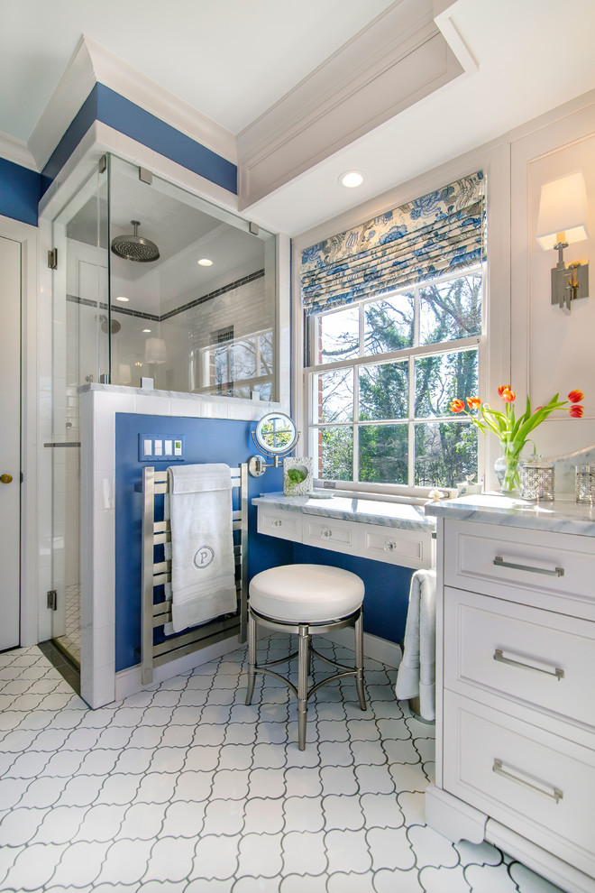 Aménagement d'une salle de bain classique avec des portes de placard blanches, une douche double, un mur bleu, un plan de toilette en marbre, une cabine de douche à porte battante, un plan de toilette gris, un sol blanc et un placard avec porte à panneau encastré.