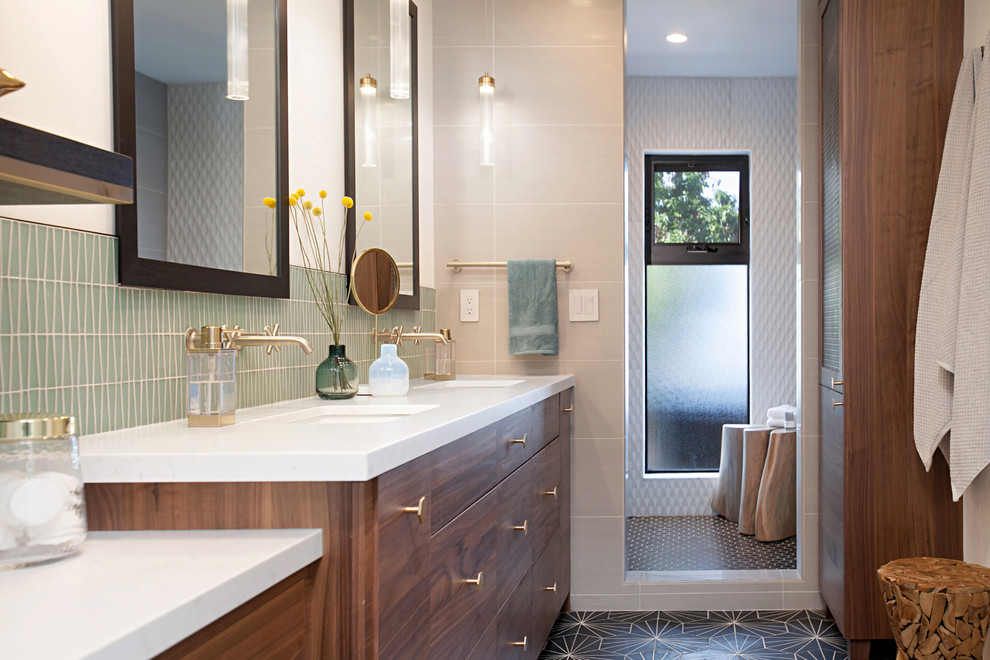 This is an example of a modern shower room bathroom in San Diego with flat-panel cabinets, medium wood cabinets, an alcove shower, grey tiles, white walls, a vessel sink, grey floors and a hinged door.