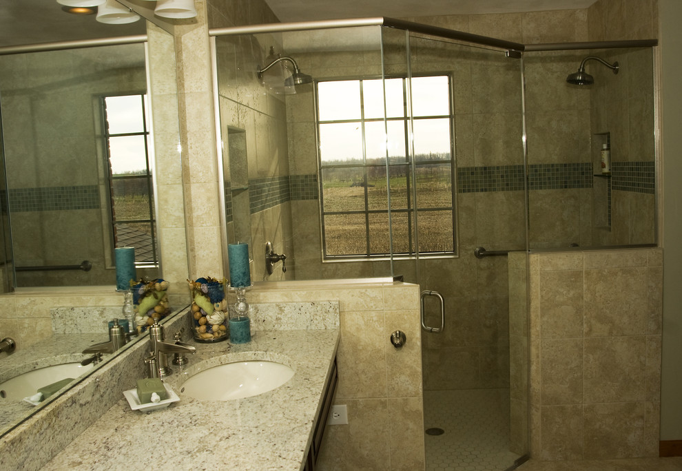 Example of a trendy beige tile and ceramic tile walk-in shower design in St Louis with an undermount sink, raised-panel cabinets, dark wood cabinets, granite countertops and a two-piece toilet