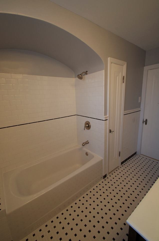 Bathroom - mid-sized craftsman master white tile and subway tile ceramic tile bathroom idea in St Louis with an integrated sink, glass-front cabinets, dark wood cabinets, solid surface countertops, a one-piece toilet and gray walls