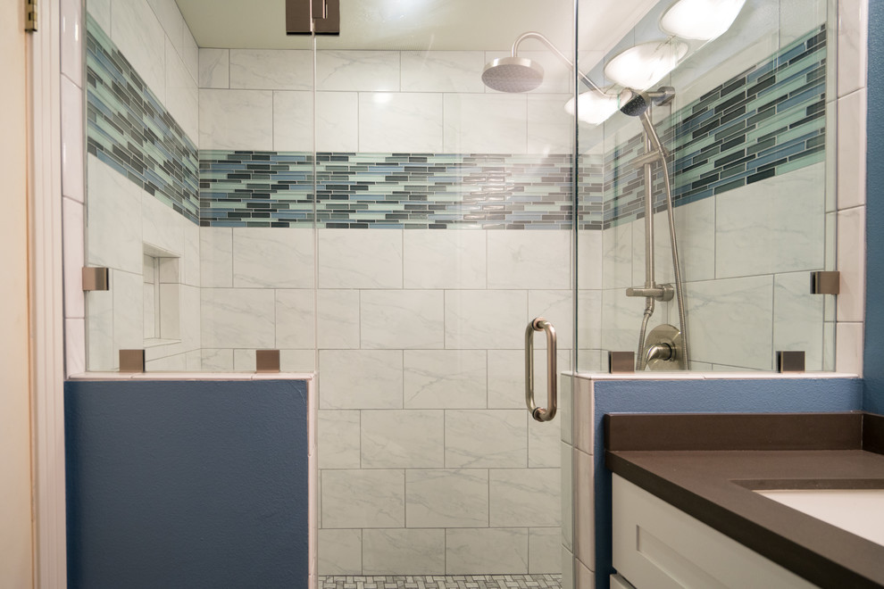 Example of a mid-sized minimalist master multicolored tile and porcelain tile porcelain tile and single-sink alcove shower design in San Diego with recessed-panel cabinets, white cabinets, a two-piece toilet, blue walls, a drop-in sink, quartz countertops, a hinged shower door, gray countertops and a built-in vanity