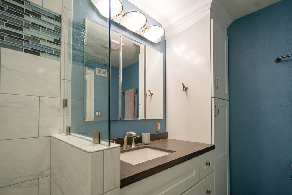 This is an example of a medium sized modern ensuite bathroom in San Diego with recessed-panel cabinets, white cabinets, an alcove shower, a two-piece toilet, multi-coloured tiles, porcelain tiles, blue walls, porcelain flooring, a built-in sink, quartz worktops, grey worktops, a single sink and a built in vanity unit.