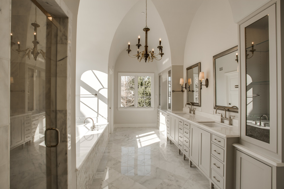 Modelo de cuarto de baño clásico con lavabo bajoencimera, armarios estilo shaker, puertas de armario grises, ducha empotrada y paredes blancas