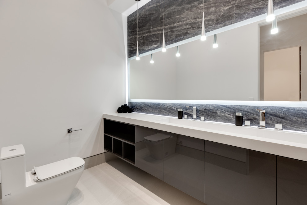 Example of a huge minimalist double-sink bathroom design in Las Vegas with brown cabinets, an integrated sink and a floating vanity