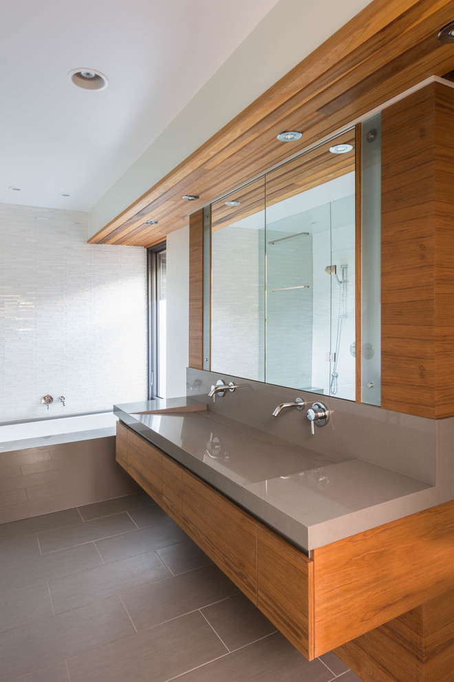 Walk-in shower - mid-sized contemporary master gray tile and glass tile porcelain tile walk-in shower idea in Toronto with an integrated sink, furniture-like cabinets, medium tone wood cabinets, quartz countertops, an undermount tub, a one-piece toilet and white walls