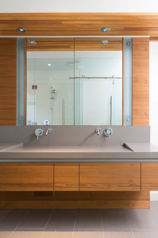 Bathroom - mid-sized contemporary master porcelain tile bathroom idea in Toronto with an integrated sink, flat-panel cabinets, medium tone wood cabinets, quartz countertops and white walls