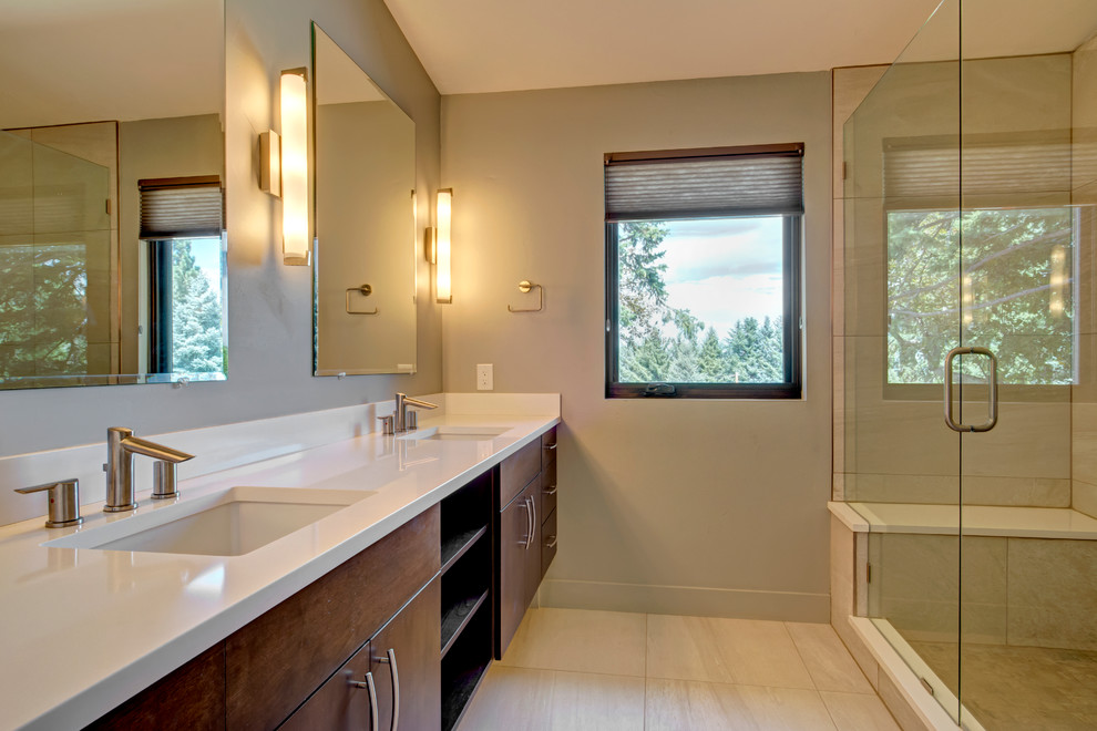 Large retro ensuite bathroom in Denver with flat-panel cabinets, dark wood cabinets, an alcove shower, white tiles, stone slabs, grey walls, porcelain flooring, a submerged sink and solid surface worktops.