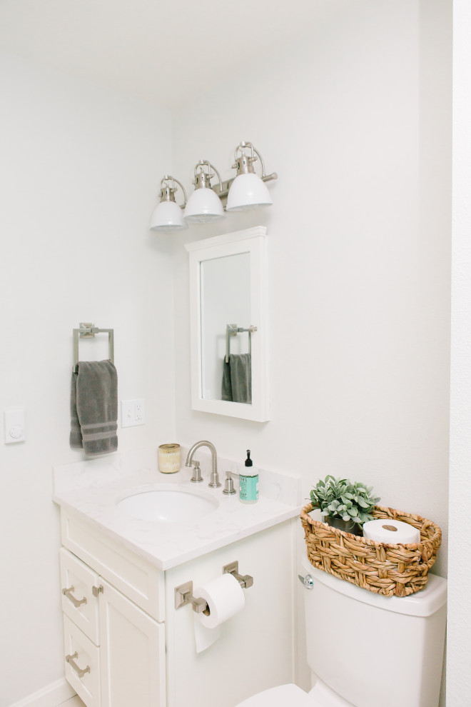 This is an example of a small modern bathroom in Seattle with shaker cabinets, white cabinets, an alcove bath, a shower/bath combination, a two-piece toilet, green tiles, glass tiles, white walls, porcelain flooring, a submerged sink, engineered stone worktops, white floors, a shower curtain and white worktops.