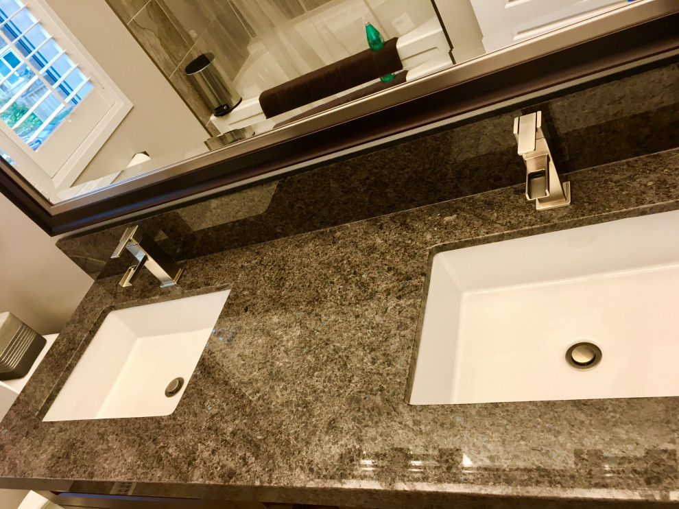 Example of a mid-sized minimalist 3/4 gray tile and porcelain tile porcelain tile, brown floor and double-sink bathroom design in Toronto with shaker cabinets, brown cabinets, a two-piece toilet, gray walls, an undermount sink, granite countertops, brown countertops and a freestanding vanity