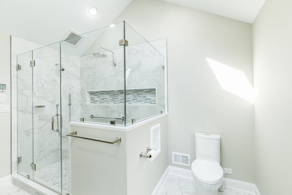 Mid-sized transitional master multicolored tile and glass tile porcelain tile, gray floor and double-sink bathroom photo in Philadelphia with recessed-panel cabinets, gray cabinets, a two-piece toilet, beige walls, an undermount sink, quartz countertops, a hinged shower door, white countertops and a built-in vanity