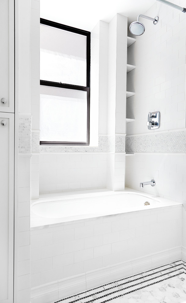 На фото: ванная комната среднего размера в стиле неоклассика (современная классика) с фасадами с утопленной филенкой, белыми фасадами, мраморной столешницей, накладной ванной, белой плиткой, керамической плиткой, врезной раковиной, душем над ванной, унитазом-моноблоком, белыми стенами и мраморным полом с