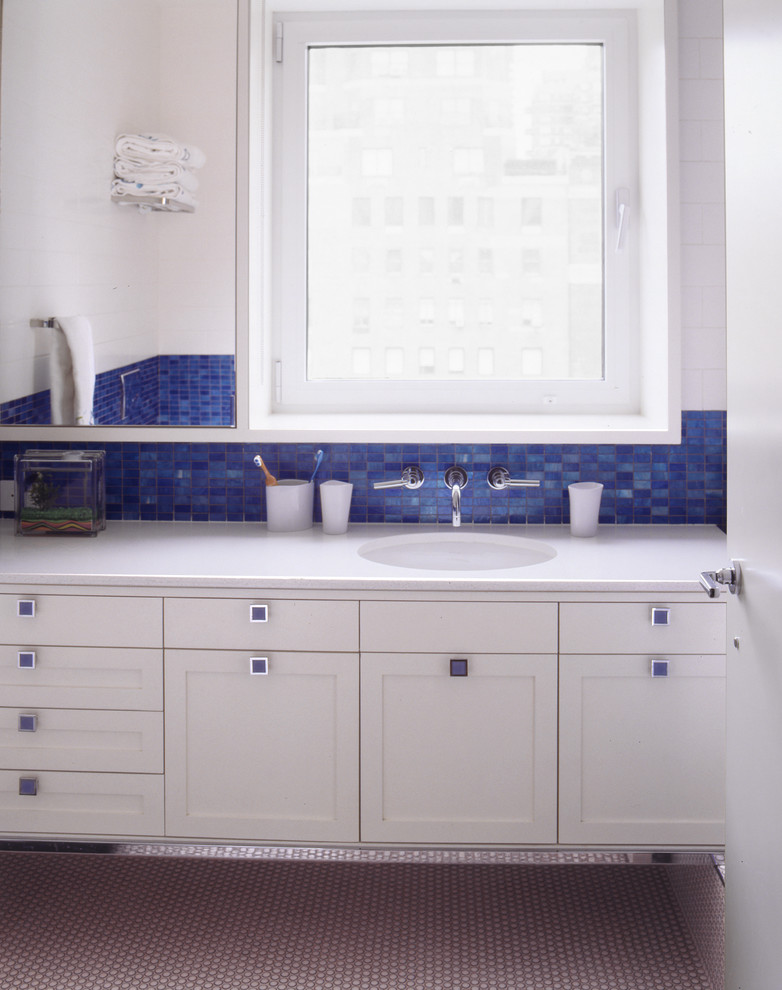Bathroom - mid-sized modern kids' blue tile porcelain tile bathroom idea in New York with recessed-panel cabinets, white cabinets, quartz countertops, white walls and an undermount sink