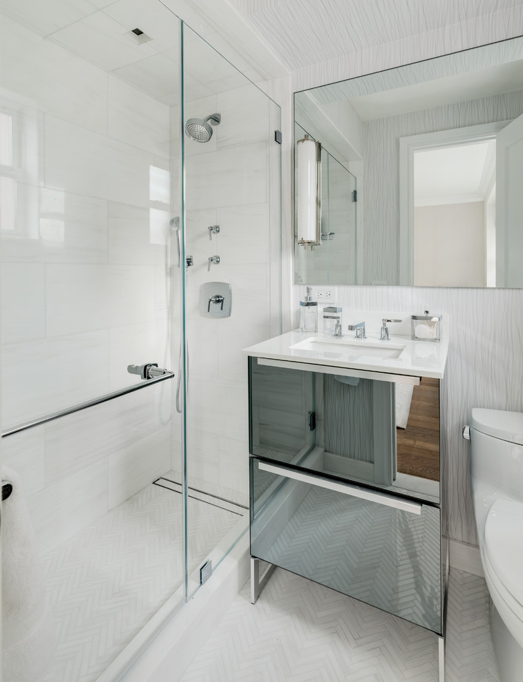 Inspiration for a small eclectic ensuite bathroom in New York with freestanding cabinets, an alcove shower, white tiles, marble tiles, mosaic tile flooring, a built-in sink, glass worktops, white floors, a hinged door and white worktops.
