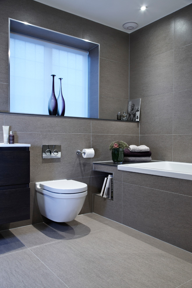 Example of a trendy bathroom design in London with a wall-mount toilet