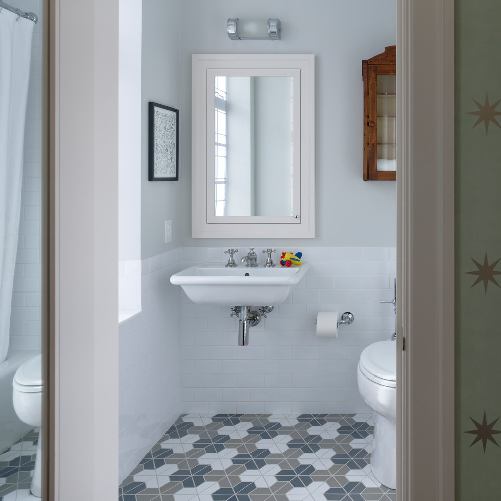 Bathroom - mid-sized cottage master medium tone wood floor bathroom idea in New York with recessed-panel cabinets, gray cabinets, a two-piece toilet, gray walls, an undermount sink and quartz countertops