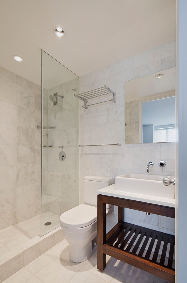 This is an example of a small modern ensuite bathroom in New York with a walk-in shower, white tiles, marble tiles, engineered stone worktops and a hinged door.
