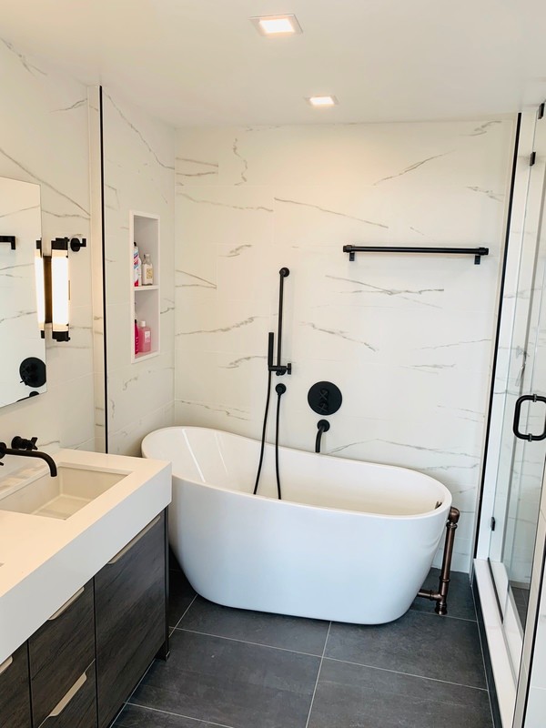 Bathroom - large modern master white tile and ceramic tile ceramic tile and gray floor bathroom idea in New York with furniture-like cabinets, brown cabinets, a wall-mount toilet, white walls, an undermount sink, quartz countertops, a hinged shower door and white countertops