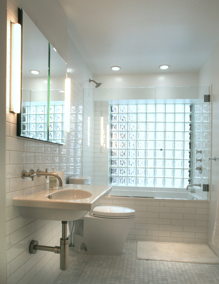 Example of a transitional white tile and subway tile bathroom design in New York with a wall-mount sink