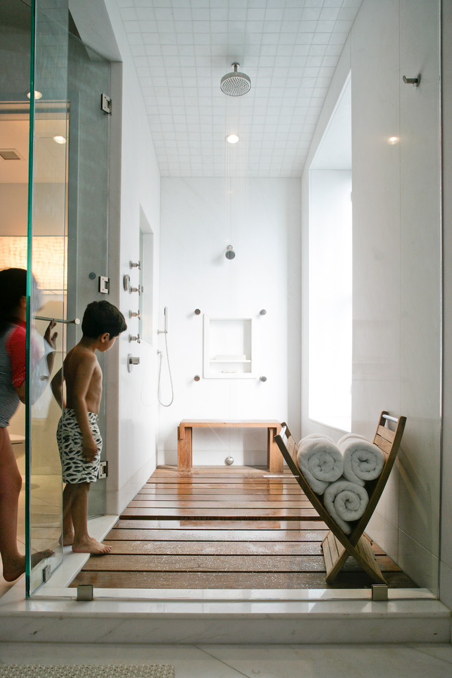 Inspiration for a mid-sized contemporary 3/4 medium tone wood floor doorless shower remodel in New York with a hinged shower door and white walls