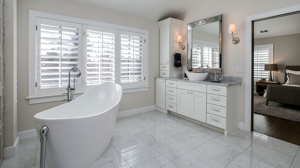 Example of a mid-sized transitional master bathroom design in Denver with flat-panel cabinets, white cabinets, a one-piece toilet, beige walls, an undermount sink and quartz countertops