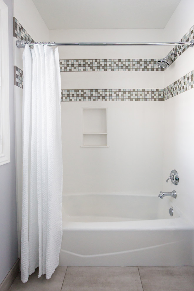 Example of a large beach style kids' multicolored tile and mosaic tile porcelain tile and gray floor bathroom design in Other with shaker cabinets, blue cabinets, a two-piece toilet, gray walls, an integrated sink, solid surface countertops, a hinged shower door and white countertops