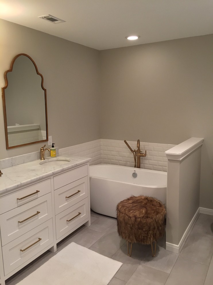 Mid-sized minimalist 3/4 white tile and ceramic tile porcelain tile freestanding bathtub photo in Dallas with shaker cabinets, white cabinets, gray walls, an undermount sink and marble countertops
