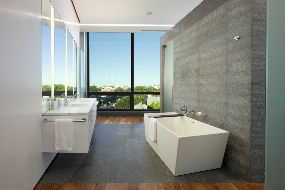 Design ideas for a modern bathroom in Minneapolis with a freestanding bath and marble worktops.