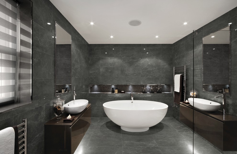 Inspiration for a contemporary master gray tile gray floor freestanding bathtub remodel in Philadelphia with flat-panel cabinets, brown cabinets, gray walls and a vessel sink