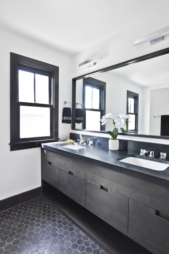 Small trendy master white tile and terra-cotta tile limestone floor and black floor corner shower photo in Nashville with flat-panel cabinets, brown cabinets, a two-piece toilet, white walls, an undermount sink, granite countertops, a hinged shower door and black countertops