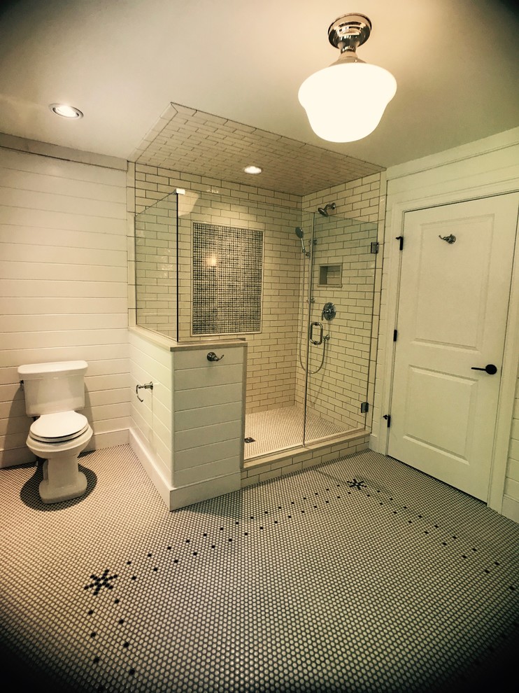 Inspiration for a large classic bathroom in Burlington with white cabinets, a two-piece toilet, white tiles, white walls, ceramic flooring, a submerged sink, a hinged door, shaker cabinets, metro tiles, solid surface worktops and white floors.