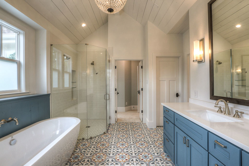 Example of a mid-sized farmhouse master multicolored tile and ceramic tile ceramic tile bathroom design in Houston with shaker cabinets, blue cabinets, white walls, an undermount sink and marble countertops
