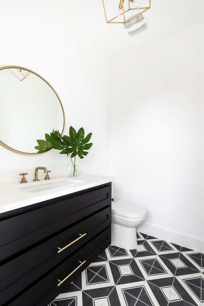 Modelo de cuarto de baño minimalista con puertas de armario negras y encimeras blancas