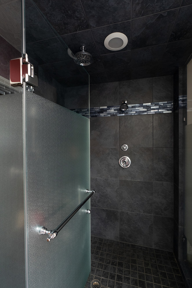 This is an example of a medium sized traditional ensuite bathroom in Calgary with recessed-panel cabinets, a built-in bath, an alcove shower, purple walls, porcelain flooring, granite worktops, grey floors, a hinged door and black worktops.