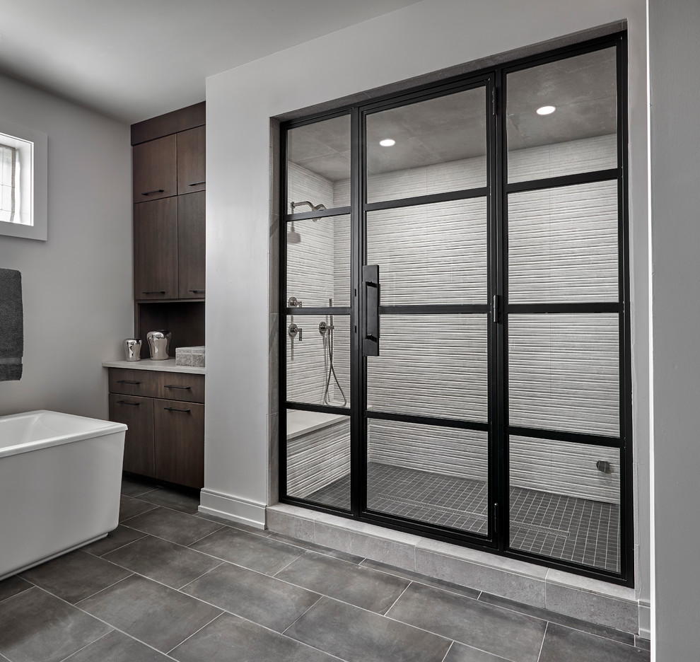 Example of a large trendy master gray tile and porcelain tile porcelain tile and gray floor bathroom design in Chicago with flat-panel cabinets, brown cabinets, a one-piece toilet, gray walls, a vessel sink, quartz countertops, a hinged shower door and gray countertops