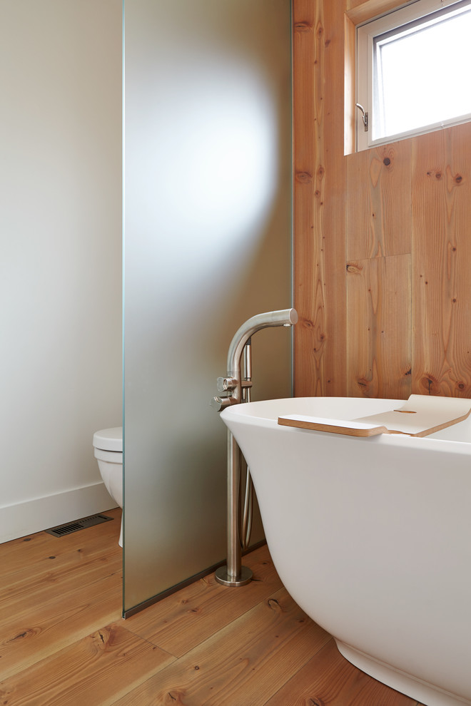 Example of a mid-sized minimalist master white tile and porcelain tile light wood floor bathroom design in Toronto with flat-panel cabinets, medium tone wood cabinets, a one-piece toilet, multicolored walls, a vessel sink, quartz countertops and a hinged shower door